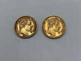 two gold sovereigns, one of which has a head of a man and the other of a woman
