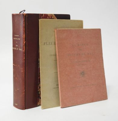three books are stacked on top of each other on a white surface