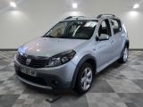 a picture of a silver dacia parked in a showroom