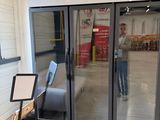 a man that is standing in front of a sliding glass door