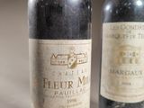 two bottles of wine sitting next to each other on a table