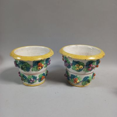 pair of yellow and white vases with flowers on them