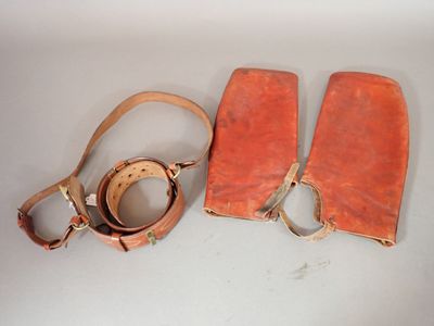 two pieces of leather on a white surface