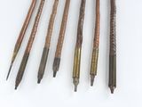 several different types of pens are lined up on a white surface