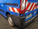a blue van with red and white stripes parked in a garage