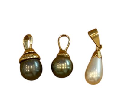three different types of pearl pendants on a white background