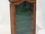 an old wooden display case with glass doors on a white background