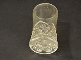 a clear glass with a design on it on a black surface