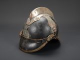 an old helmet with a metal decoration on the side of it