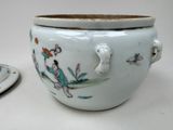 a white bowl with a lid and a plate with a bird on it