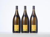 three bottles of wine sitting on top of a table next to each other