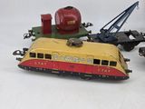 several toy trains are lined up on a white surface