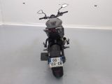a motorcycle parked in a room with a number plate on the back of it