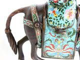 a statue of a horse with a saddle on it ' s back