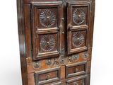an old wooden cabinet with four drawers and a door