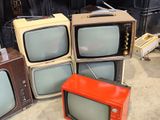 four televisions sitting next to each other on the floor