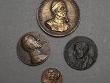 three coins are shown on a gray surface, one has a bust and the other has a bust