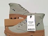 a pair of grey shoes with a tag on them