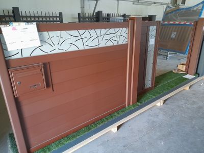 a brown gate with a sign on top of it
