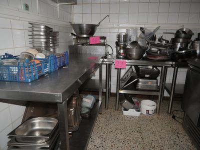many pots and pans on the counter in the kitchen