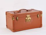 a brown suitcase sitting on top of a white surface