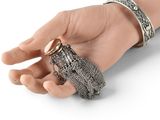 someone is holding a ring and a bracelet in their hand