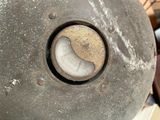 a close up of a metal object with a clock on it