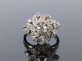 a close up of a diamond ring on a reflective surface
