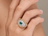 a close up of a woman ' s hand with a ring on it
