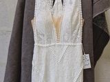 an image of a white dress hanging on a hanger