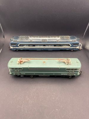 three toy train cars are lined up in a row on a gray surface