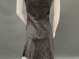 the back of a mannequin wearing a gray dress and black shoes