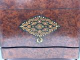 a small wooden box with a decorative design on it