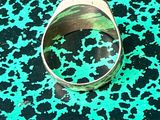 a ring that is sitting on a green and black surface
