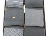 six pairs of men ' s socks in a box on a table