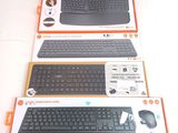 three different keyboards and mouses in boxes on the table