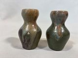two vases that are sitting on a white surface