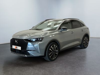 a grey car parked in a room with a white wall