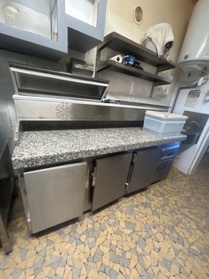 a kitchen with stainless steel cabinets and a counter top