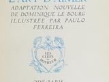 an old book with blue writing on it sitting on top of a table