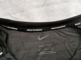 the back of a black nike running shirt with a white nike logo on it