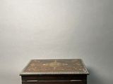 an old wooden box sitting on top of a gray surface