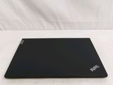 a black laptop sitting on a white surface