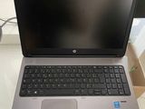 hp laptop with keyboard and mouse sitting on a desk in front of a computer monitor
