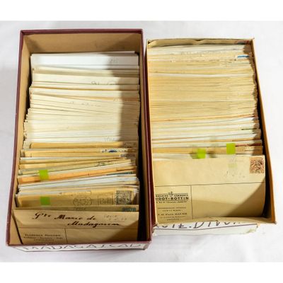 two boxes filled with lots of old papers sitting on top of a table