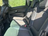 the back seats of a car with a green seat cover