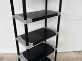 a close up of a black and silver shelf with three shelves