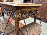 a wooden table with a shelf on top of it