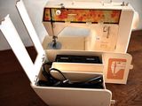 a sewing machine that is sitting in a box on a table