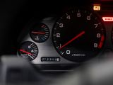 a close up of a car dashboard with a speedometer and gauges